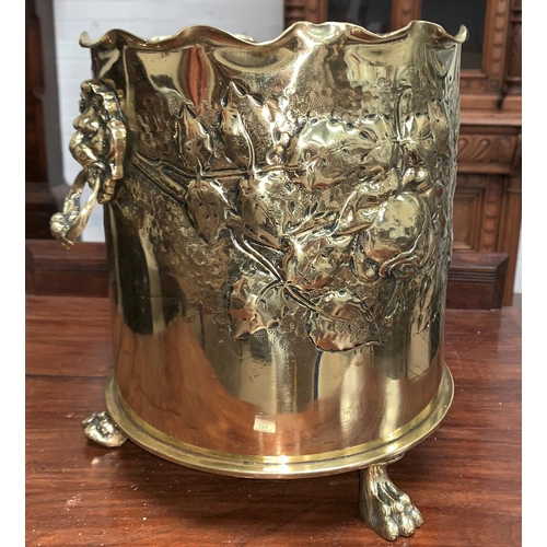407A - A WW1 “Trench Art” jardinière with lion mask and ring handles, relief trailing flower and
leaf decor... 