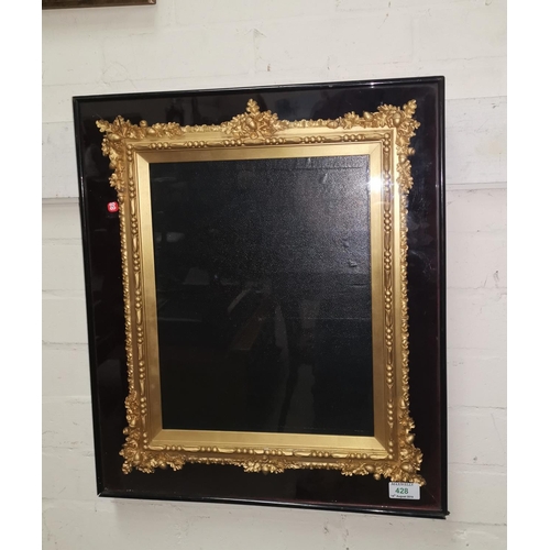 428 - A Victorian glazed cabinet frame with ornate gilt mount, inset size 35 cm x 28 cm