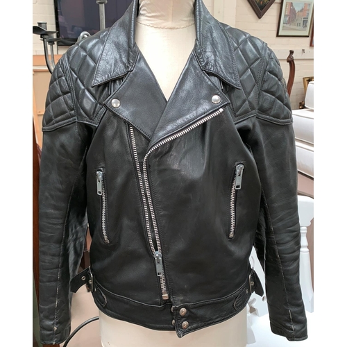 437A - A Vintage “T.T.Leathers” black leather biker jacket with red quilted lining 107cm 42”.