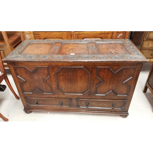 524 - An early 20th century oak mule chest with carved and moulded decoration