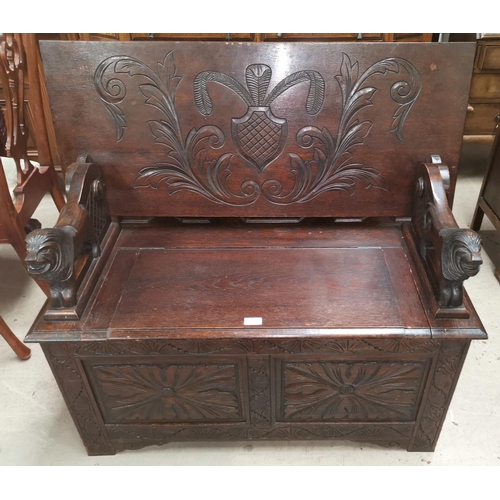 527 - An early 20th century carved oak monks bench