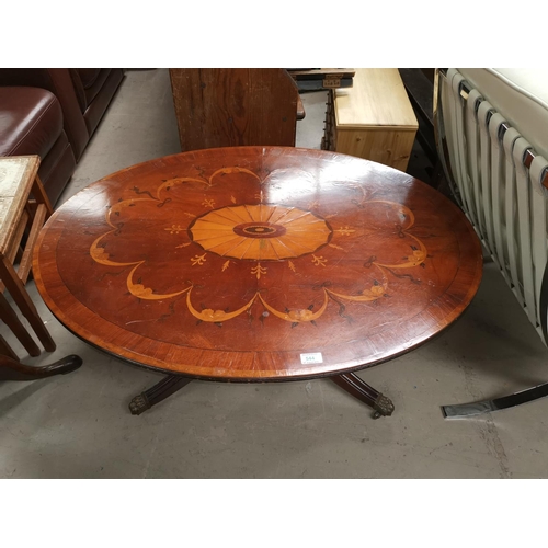 544 - A reproduction mahogany pedestal coffee table with oval top