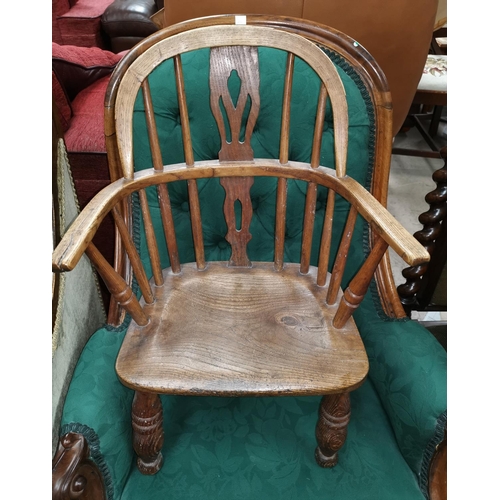 551 - A 19th century child's elm Windsor armchair with pierced splat and solid seat, on turned legs