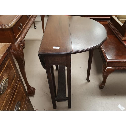 590 - A 1930's cane back low seat armchair;An early 20th century mahogany drop leaf occasional table