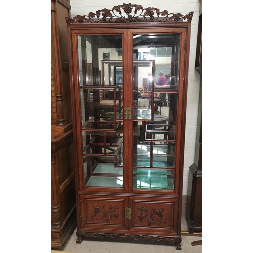 601 - A mid 20th century Chinese hardwood display cabinet with vine carved decoration, 2 glazed doors, 2 p... 