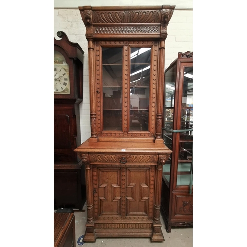 606 - A Victorian Gothic revival medium oak bookcase, full height, the upper section with carved moulded f... 