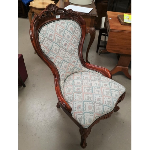 623 - A Victorian style nursing chair with balloon back, in floral fabric