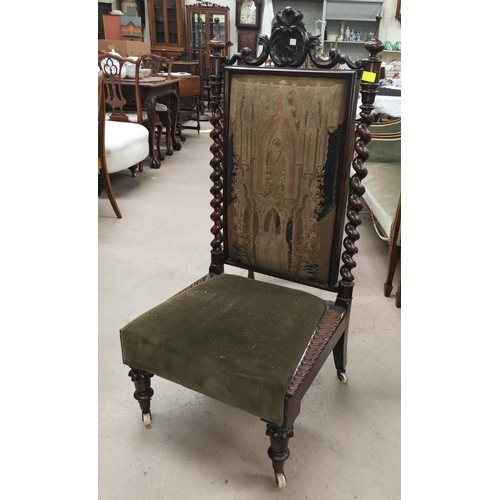 657 - A Jacobean style rosewood nursing chair with barley twist columns and carved crest, needlwork back, ... 