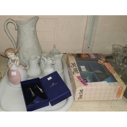 250 - A collection of 6 Portmeirion bisque jugs; a boxed doll's tea set; a Nao figure; a boxed pair of Swa... 