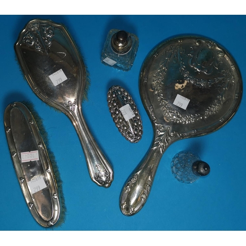 299 - A two piece hallmarked backed brush and mirror set Chester 1914, a silver backed brush, a silver lid... 