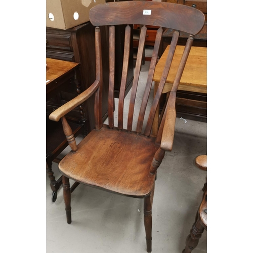 616 - A 19th century beech armchair with lath back and solid seat