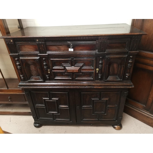 532 - An 18th/19th oak unusual side cabinet in the William & Mary style, the upper section with single doo... 
