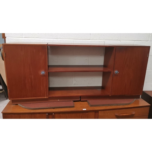 635 - A France and Son teak side unit with central shelves and cupboards to either end