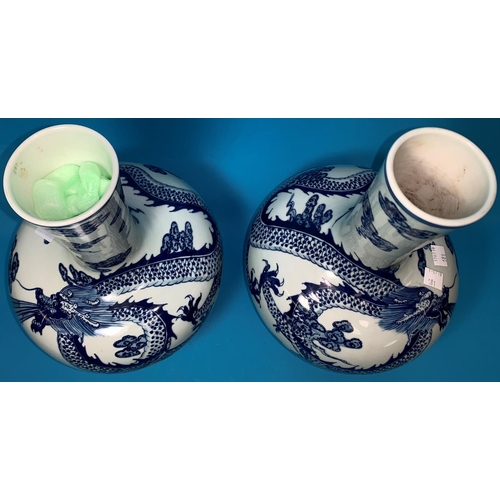 181 - A Chinese pair of globular vases with underglaze blue decoration of dragons, 12