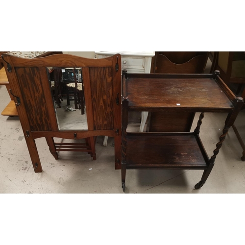 510 - A 1930's oak drop leaf dining table with 'D' end; an oak 2 tier barley twist tea trolley; a wall mou... 