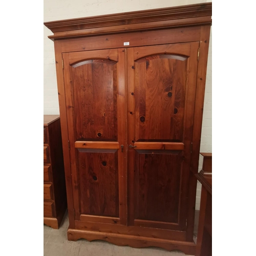 586 - A Victorian style pine bedroom suite comprising double wardrobe, chest of 4 long and 2 short drawers... 