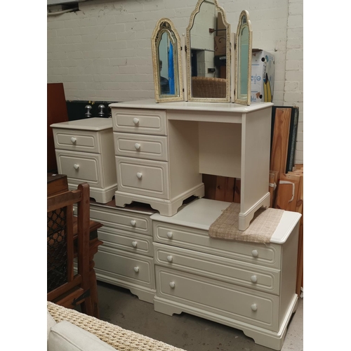 603 - A white laminate bedroom suite comprising 2 x 3 height chests; 2 height bedside cabinet and dressing... 