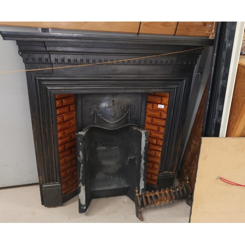624 - A Victorian cast iron back leaded fireplace with brown tile insets