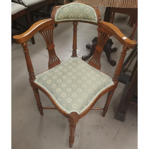 647 - A pair of Edwardian corner armchairs, upholstered seats in green, on turned legs