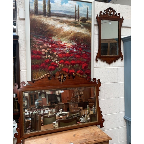 594 - A large early 20th century wall mirror in Chippendale style fretwork frame; a similar smaller mirror