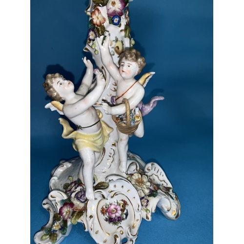 164 - A Dresden style large encrusted table centre decorated with 2 cherubs, height 14