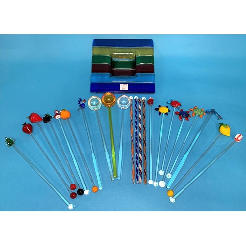 170 - A collection of 21 coloured glass swizzle sticks decorated with fruit; etc.