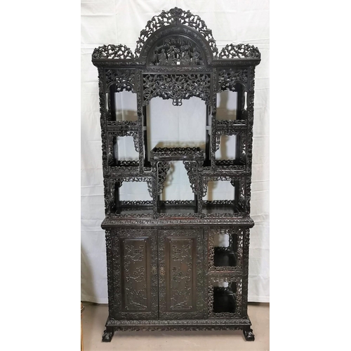 320 - A late 19th century Chinese hardwood full height display cabinet with extensive carving and pierced ... 