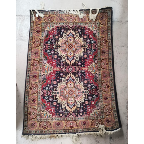 244 - A middle eastern hand knotted rug decorated with multicoloured geometric patterns, 58