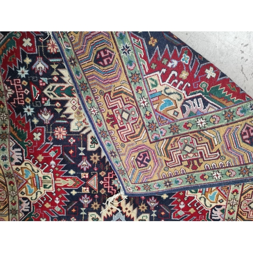 244 - A middle eastern hand knotted rug decorated with multicoloured geometric patterns, 58
