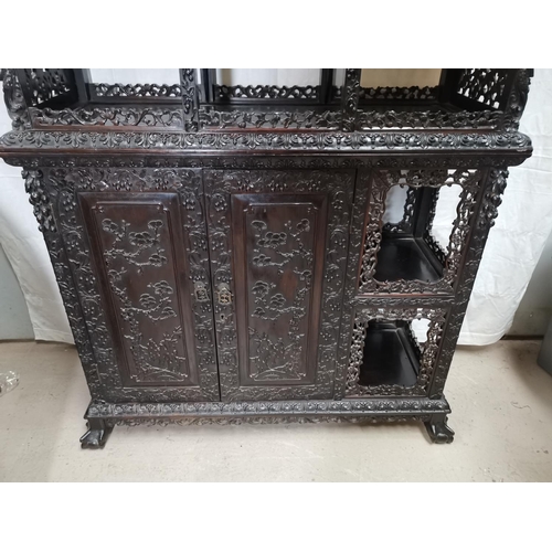 320 - A late 19th century Chinese hardwood full height display cabinet with extensive carving and pierced ... 