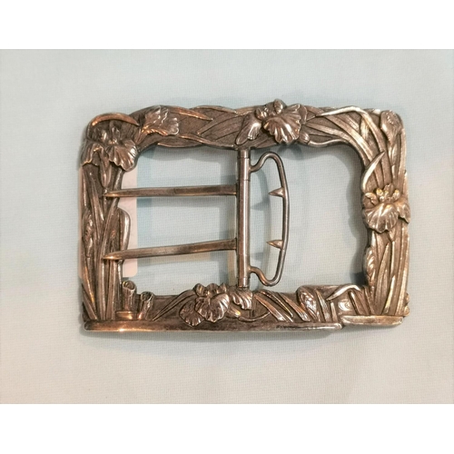 353 - A nurse's white metal large rectangular buckle, with iris in relief, stamped 'sterling', by Arthur &... 