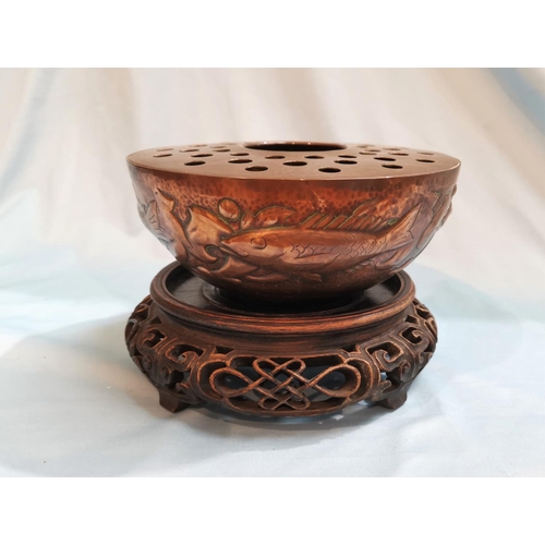 510 - A Newlyn circular copper bowl with flower separator, planished and decorated with fish, etc., impres... 