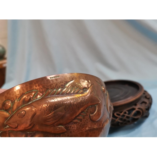 510 - A Newlyn circular copper bowl with flower separator, planished and decorated with fish, etc., impres... 