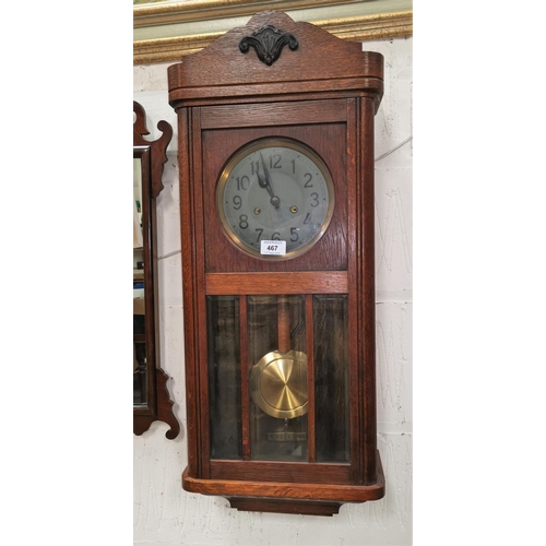 467 - A 1930's oak cased wall clock with silvered dial, bevelled glass etc