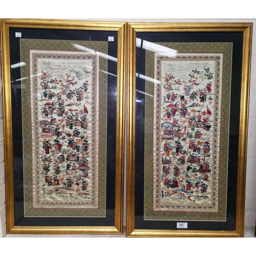 251 - A pair of Chinese embroidered silk panels decorated with groups of figures, 57 cm x 24 cm, framed an... 