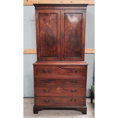 540 - A George III mahogany secretaire/cabinet, the upper section with twin figured panelled doors, the ba... 