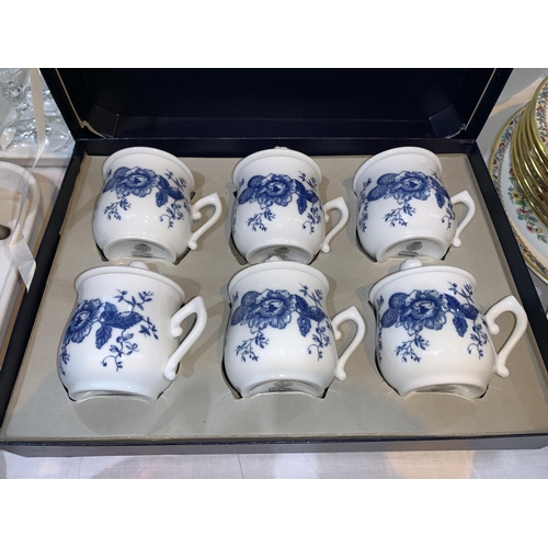 183 - A set of 6 Royal Worcester porcelain chocolate pots and matching tray, boxed. A Cranberry claret jug... 