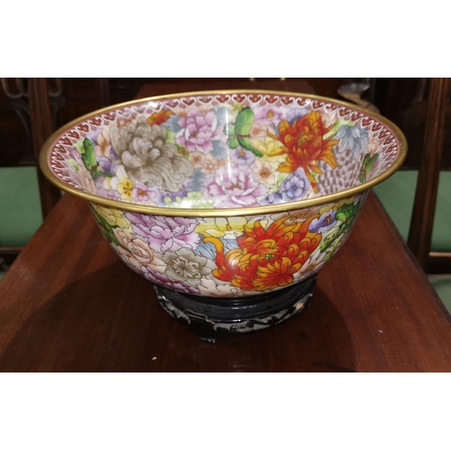 460 - A large modern cloisonne bowl decorated in polychrome with chrysanthemums etc on an ebonised base of... 