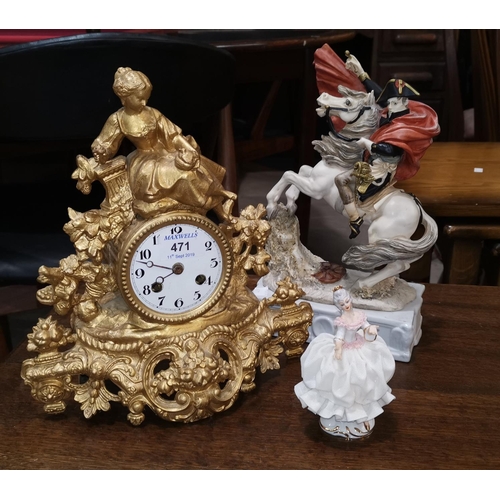 471 - A 19th century French mantel clock in gilt metal case, surmounted by a woman with dove, white enamel... 