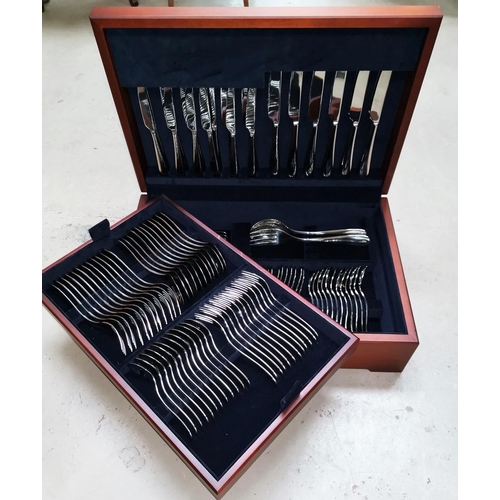 399 - A 6 setting canteen of Alessi stainless steel cutlery in mahogany case