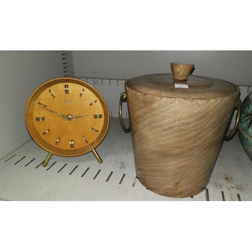 487 - A 1960's Kienzle mantel clock in polished wood case; a polished wood ice bucket with brass handles, ... 