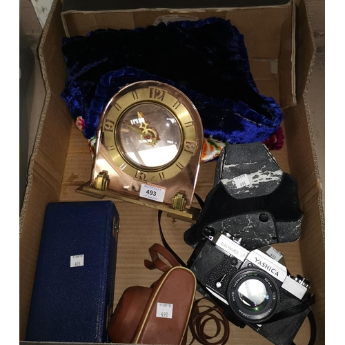 493 - An Art Deco style mirror clock; 2 cameras; a set of gaming chips, boxed; 2 cushion covers