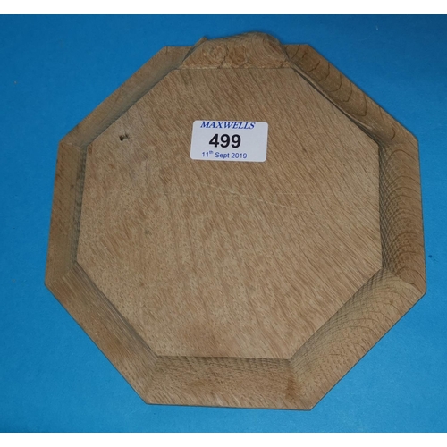 499 - A Mouseman style oak octagonal cheeseboard, 20 cm