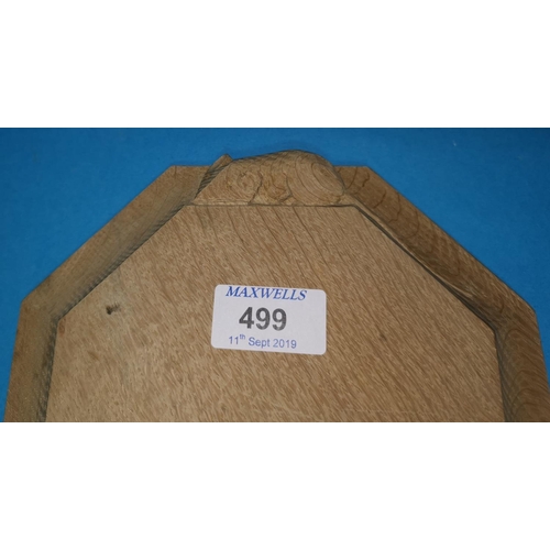 499 - A Mouseman style oak octagonal cheeseboard, 20 cm