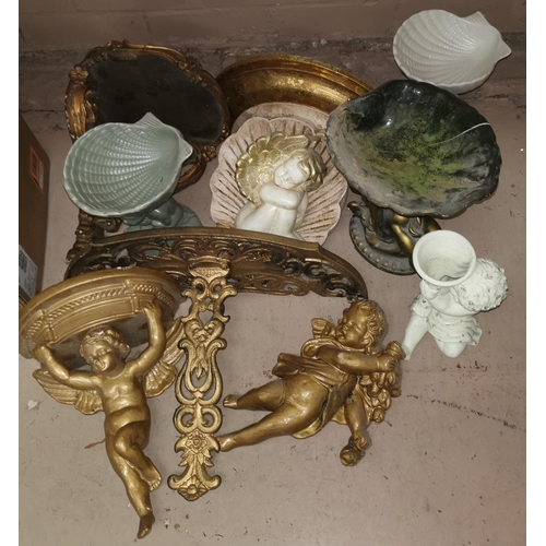 512 - A selection of gilt wall shelves featuring cherub decoration