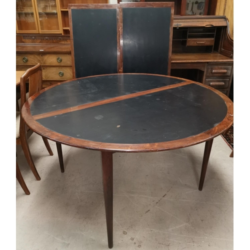 538 - A 20th Century designer Scandinavian rosewood table and chairs, the table a circular extending dinin... 