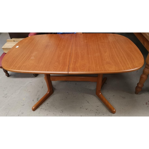 544 - A 1960's teak extending dining table with rounded rectangular top