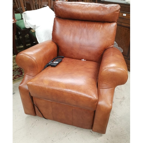 545 - An electric reclining armchair in tan hide