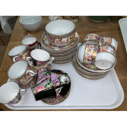 182C - A continental 32 piece part tea service with wide gilt polychrome floral border; 10 pieces of Royal ... 