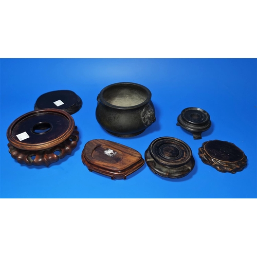 164a - A Chinese bronze censer and a selection of hardwood stands